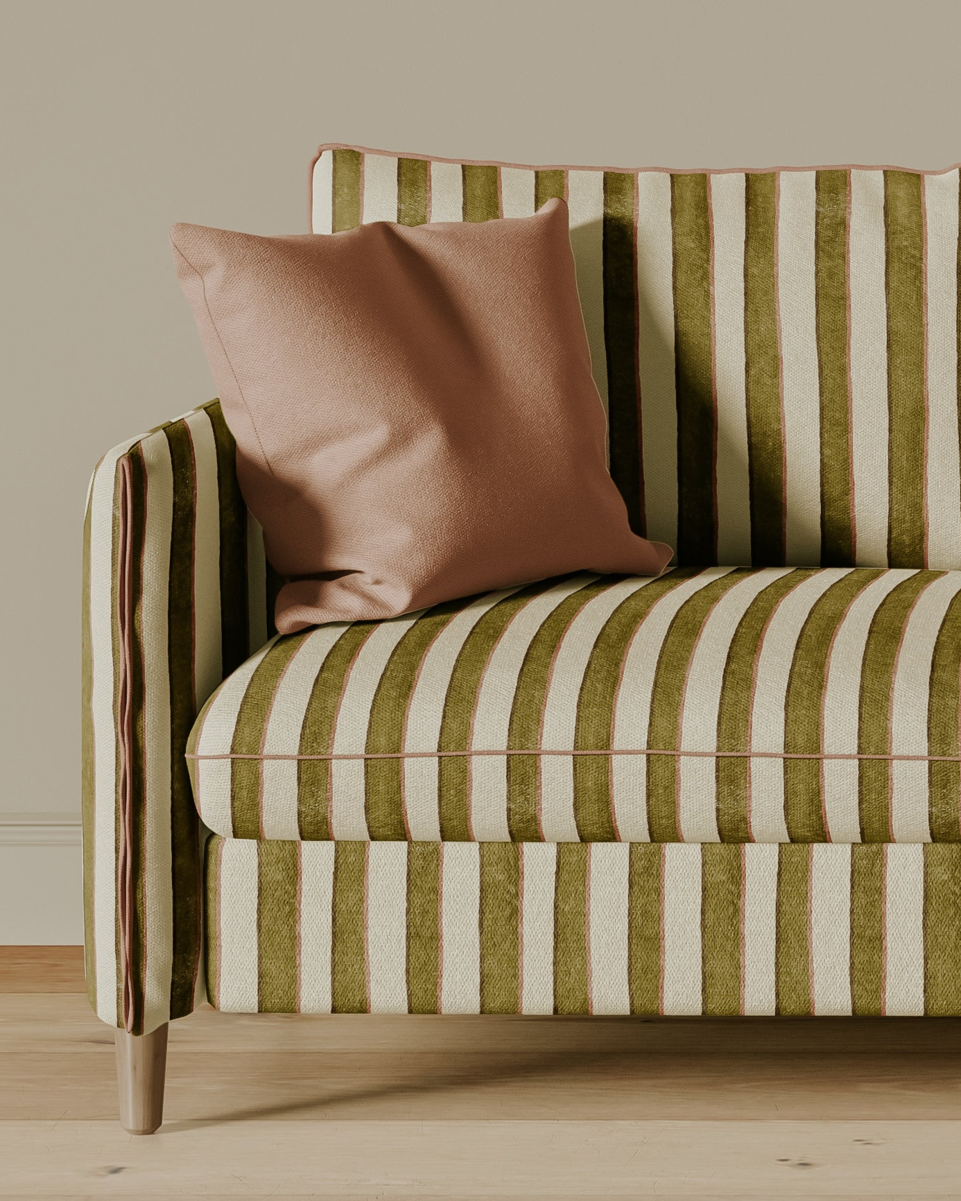 Striped sofa with pink cushions against a beige wall